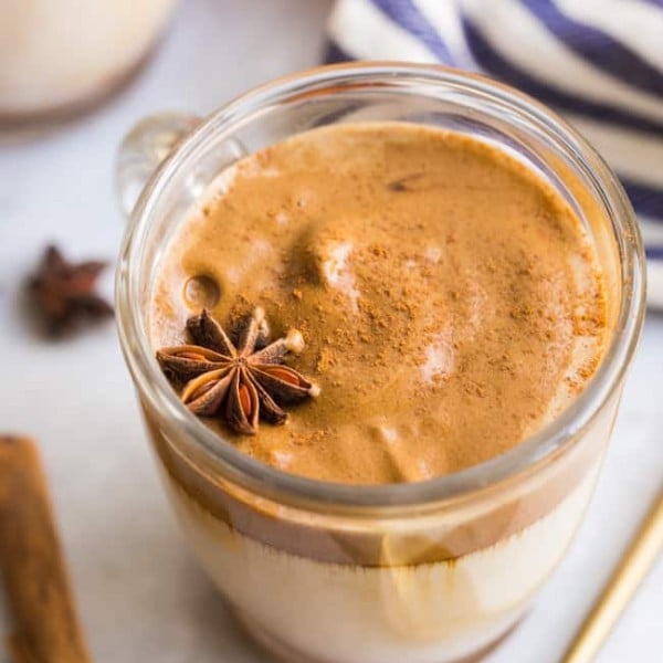 pumpkin spice dalgona topped with star anise in a glass mug