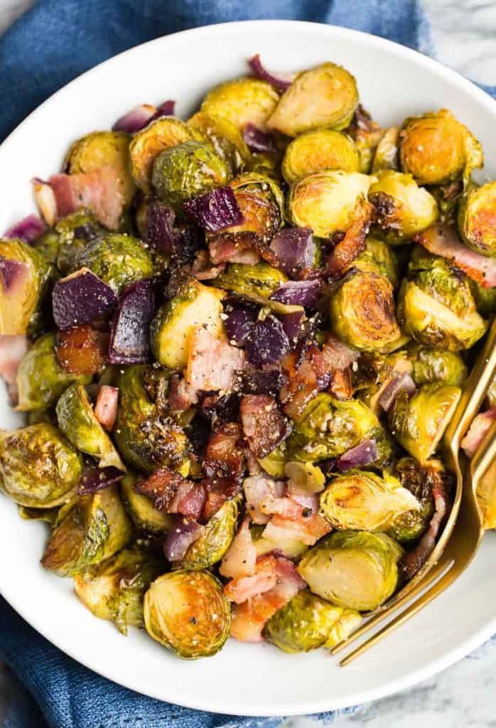 Roasted Maple Bacon Brussels Sprouts in a bowl sprinkled with pepper
