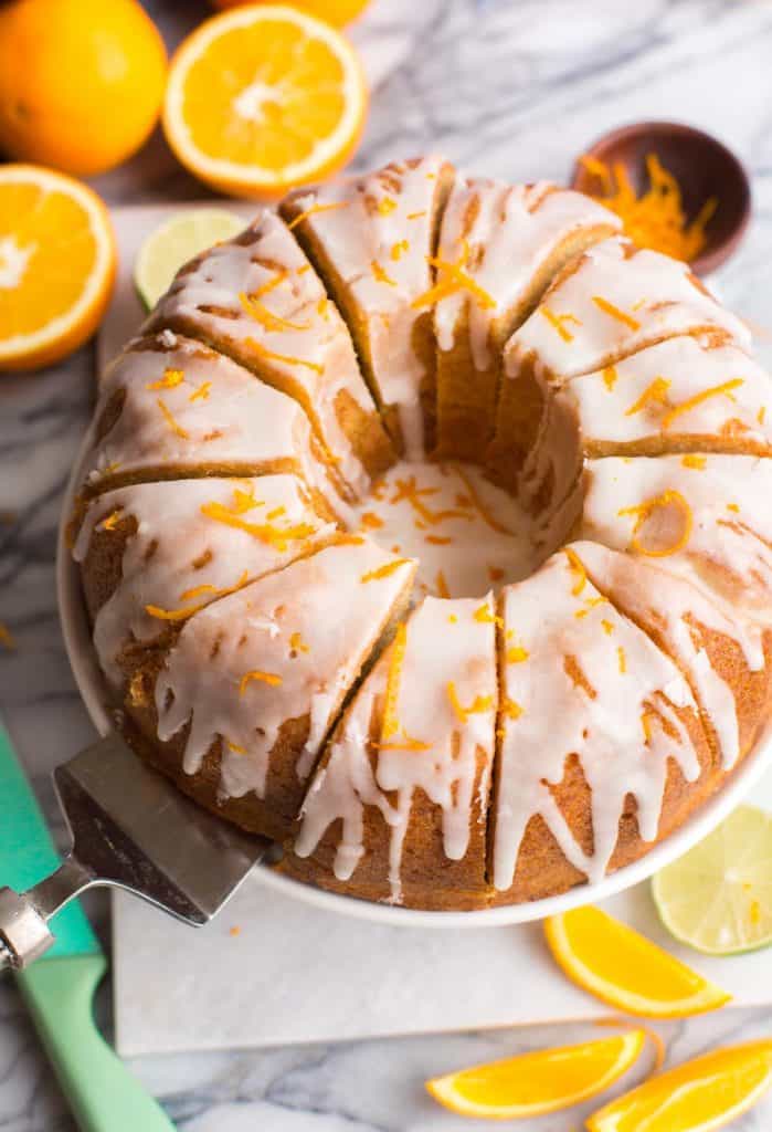 sliced Boozy Orange Drizzle Cake on a cake stand