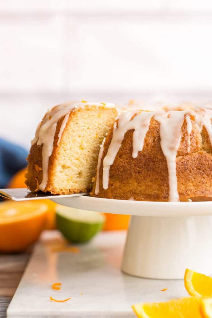 spatula lifting a slice of Orange Drizzle Cake 