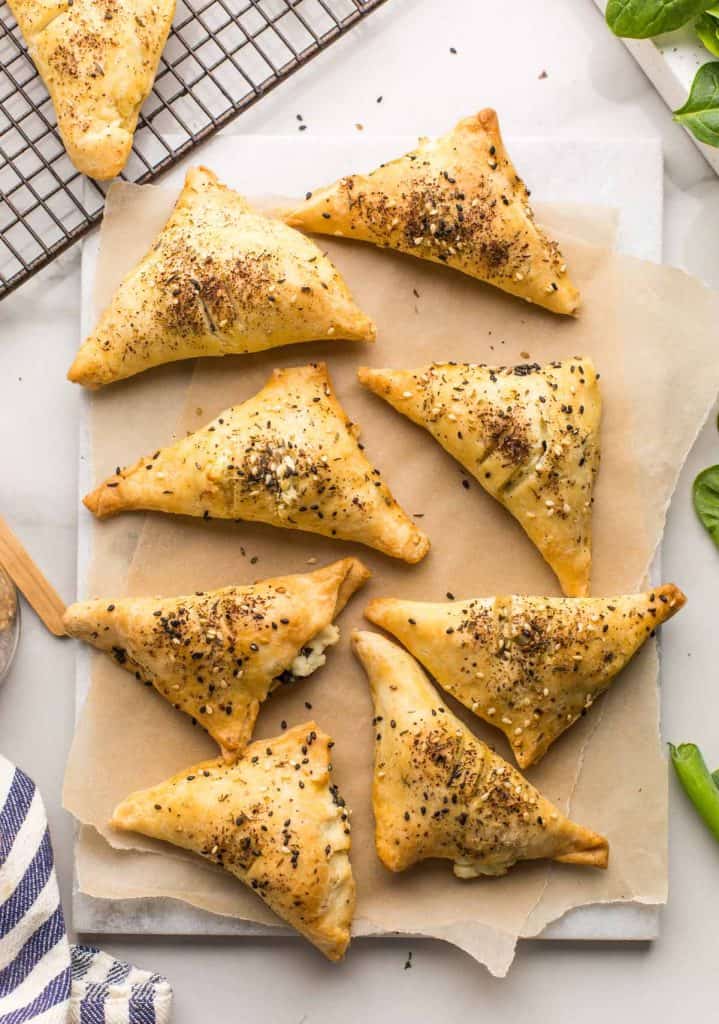 Gluten Free Spinach & Feta Parcels on a marble serving board