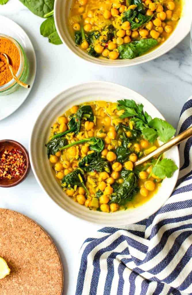 Chickpea Soup in a bowl topped with fresh herbs