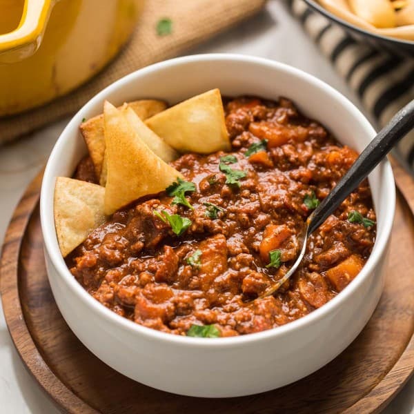 Smokey Sweet Potato Chocolate Chili in a white bowl with tortilla chips