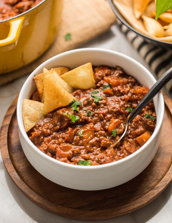 Smokey Sweet Potato Chocolate Chili in a white bowl with tortilla chips