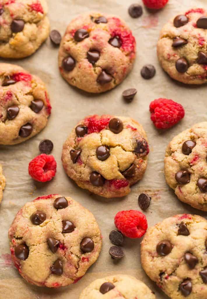 Almond Flour Raspberry Chocolate Chip Cookies surrounded by raspberries and chocolate chips
