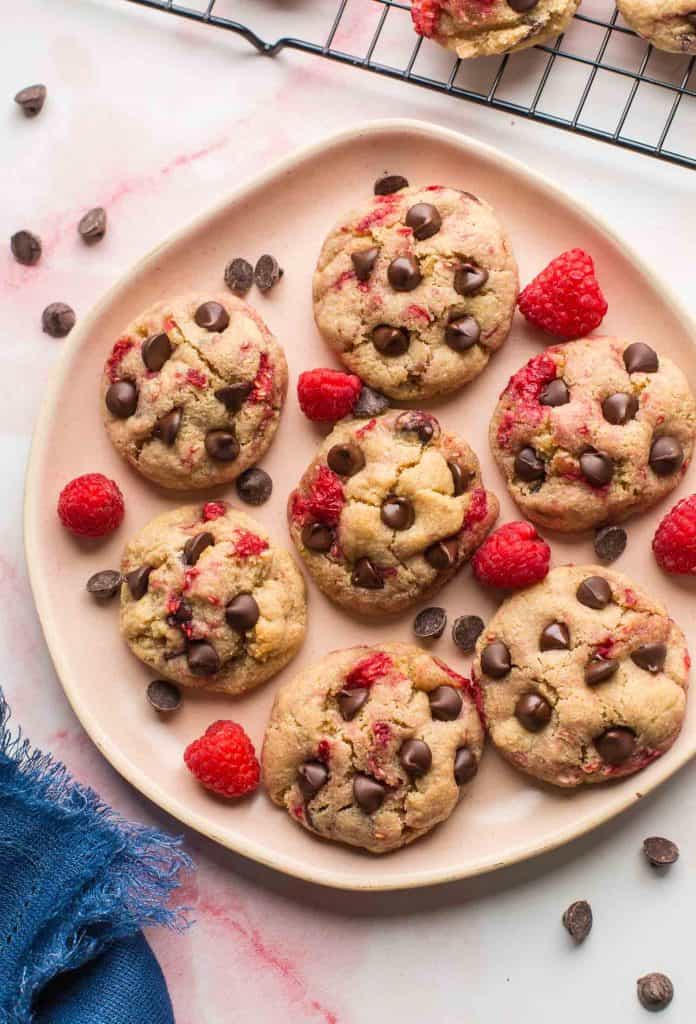 Almond Flour Raspberry Chocolate Chip Cookies on a plate with raspberries and chocolate chips