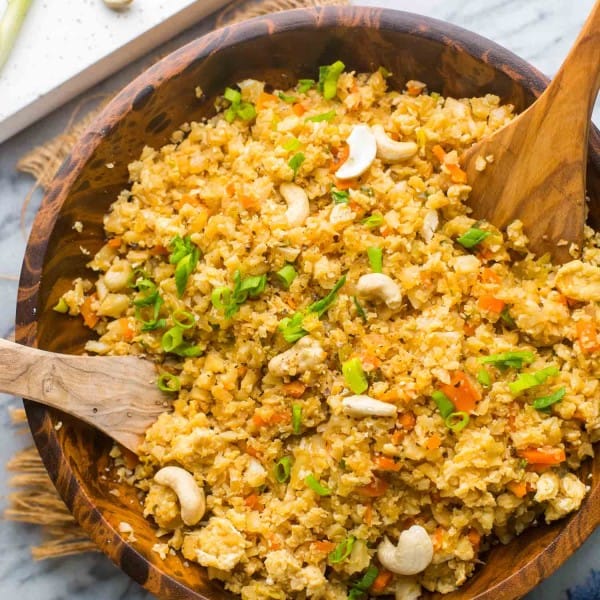 Cauliflower Egg Fried Rice in a wooden serving bowl