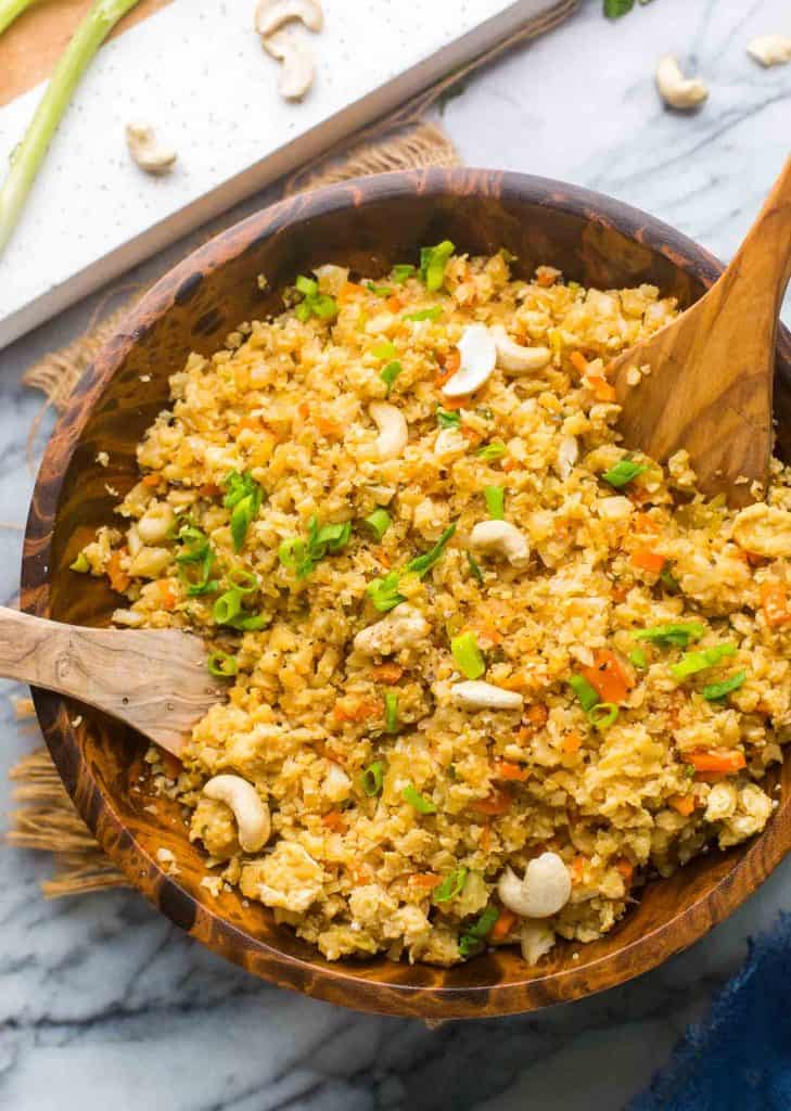 Cauliflower Egg Fried Rice in a wooden serving bowl
