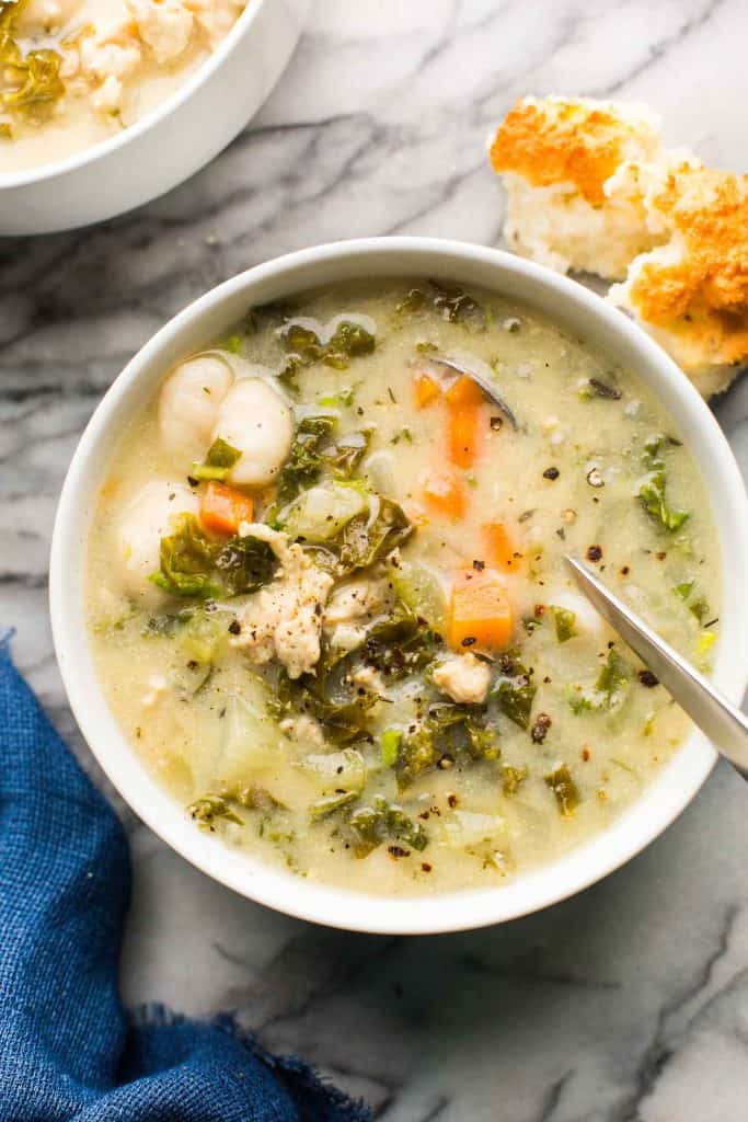 white soup bowl full of Creamy Chicken Gnocchi Soup