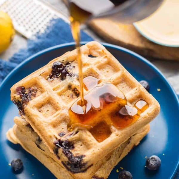 Gluten Free Blueberry Waffles with syrup pouring over top