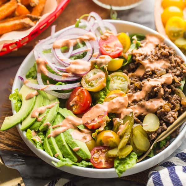 Low Carb Burger Bowls with sweet potato fries in a red basket