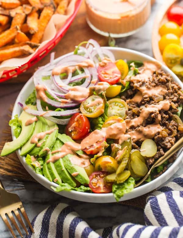 Low Carb Burger Bowls with sweet potato fries in a red basket