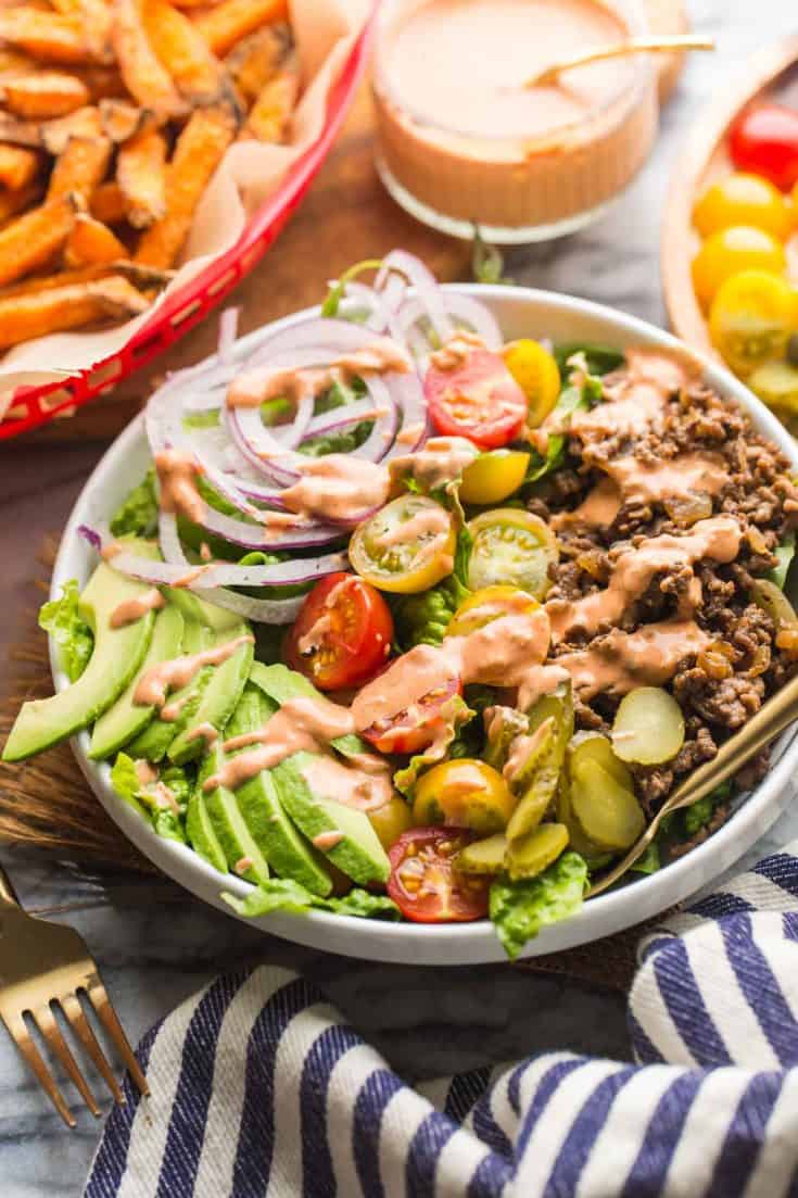 Low Carb Burger Bowls with sweet potato fries in a red basket