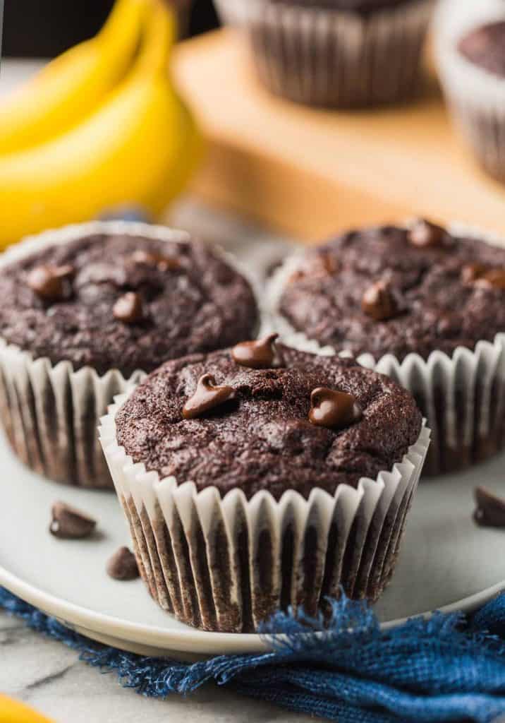 three Paleo Chocolate Banana Muffins on a small blue plate