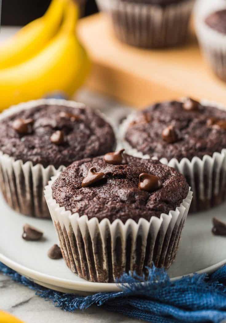 three Paleo Chocolate Banana Muffins on a small plate