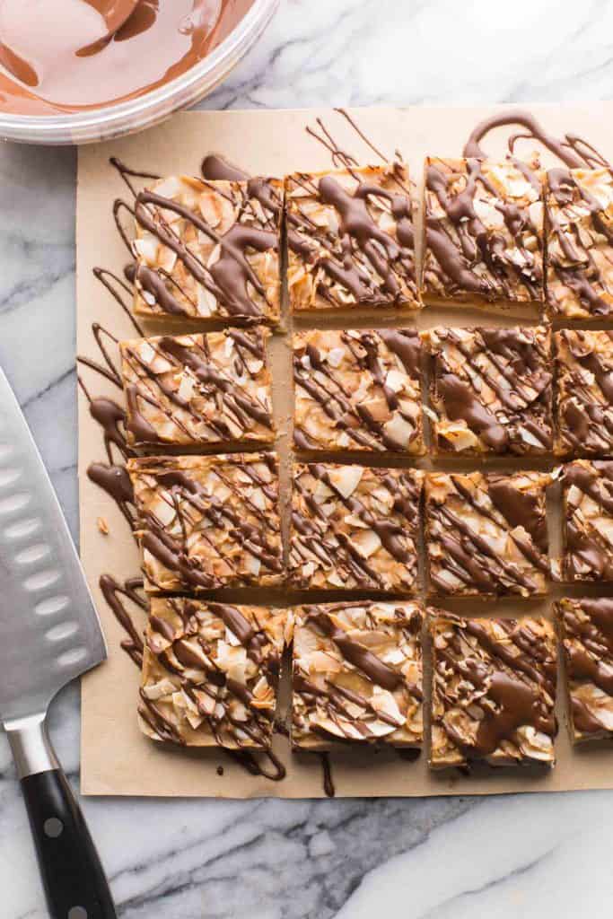 Healthier No Bake Samoas Cookie Bars sliced and drizzled with chocolate 