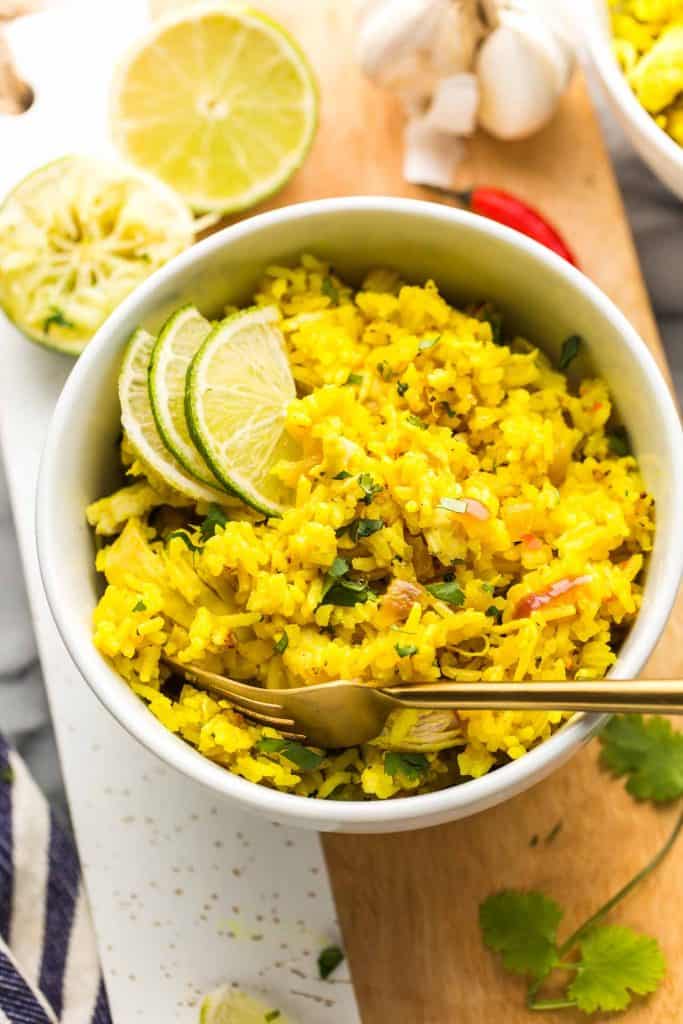 Instant Pot Coconut Lime Chicken and Rice in a white serving bowl with a gold fork