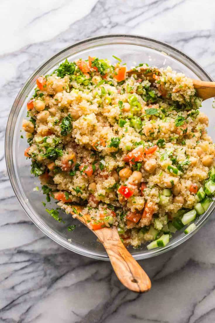 Tabbouleh Chickpea Quinoa Salad in a salad bowl with salad tongs