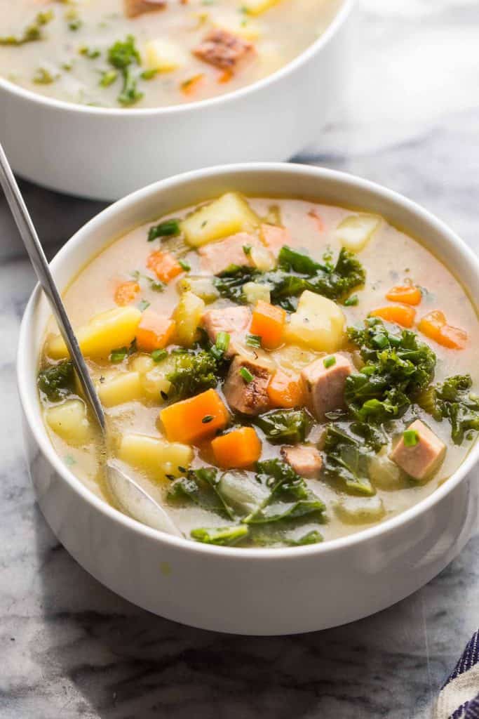 Dairy Free Ham and Potato Soup in a white soup bowl with a spoon