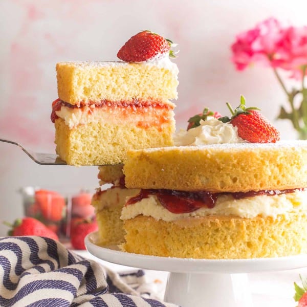 slice of Gluten Free Victoria Sponge Cake held up