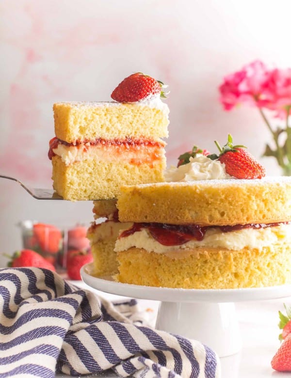 slice of Gluten Free Victoria Sponge Cake held up