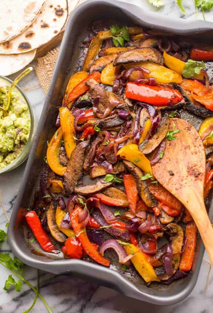 Portobello Mushroom Fajitas in a roasting tray with fresh cilantro 