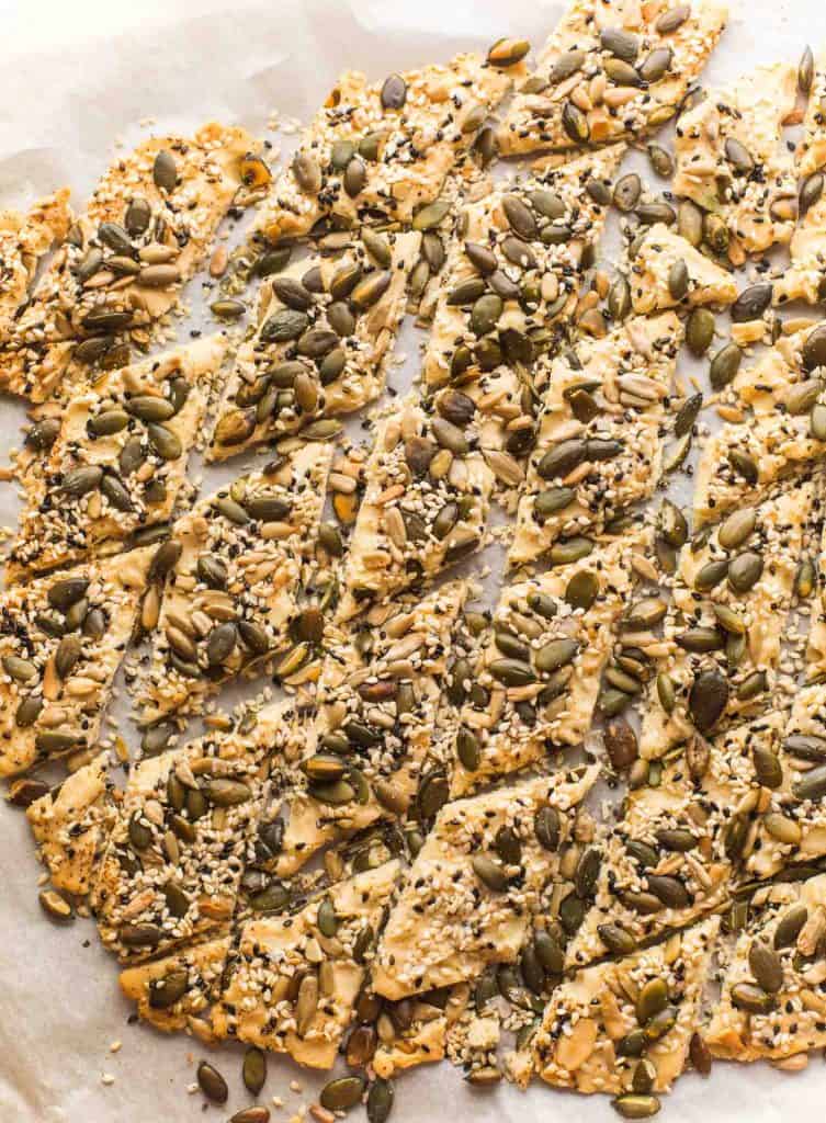 Seedy Everything Seasoned Crackers cut into crackers on baking paper