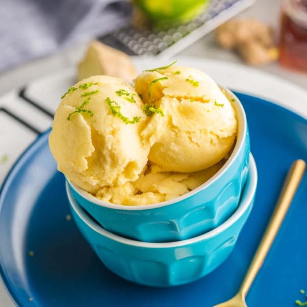 a couple of scoops of Gingery-Lime-Pineapple-Frozen-Yoghurt in a couple of stacked ice cream bowls on a plate