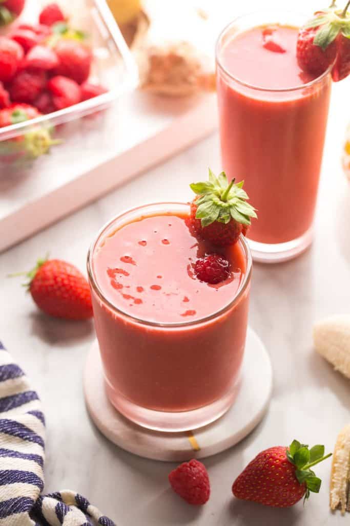 Berry Ginger Smoothie in a small glass topped with berries