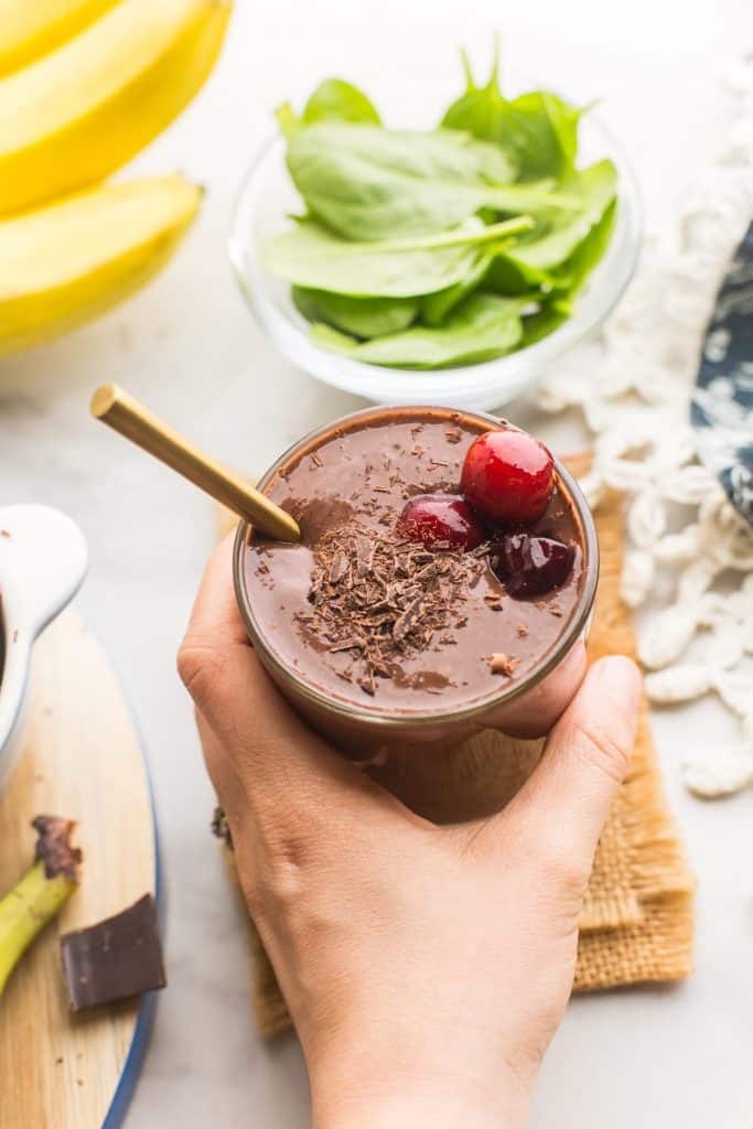 hand grabbing a glass of Chocolate Cherry Smoothie