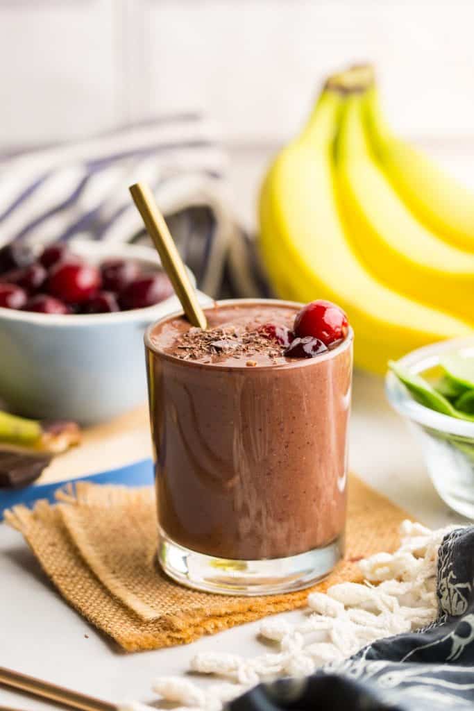 Black Forest Smoothie surrounded by fresh fruit