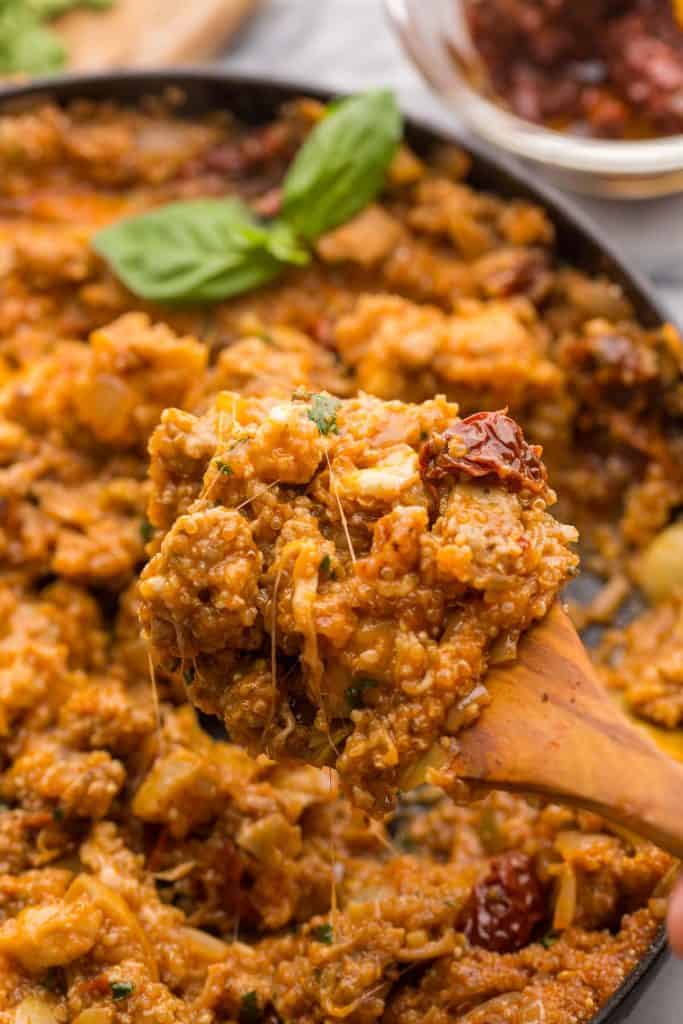 spoon picking up a heaping serving of Stove Top Italian Sausage Quinoa Casserole