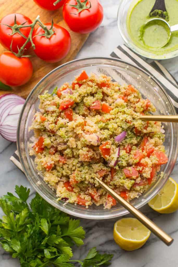 tomato quinoa salad mixed together in a salad bowl 