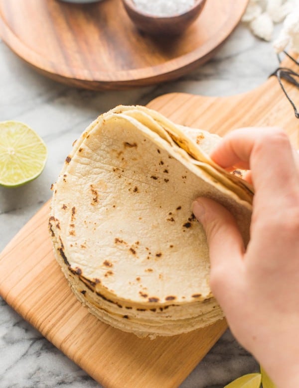 Homemade Corn Tortilla Recipe stack on a small cutting board