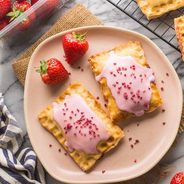 two Strawberry Gluten Free Pop Tarts on pine plate