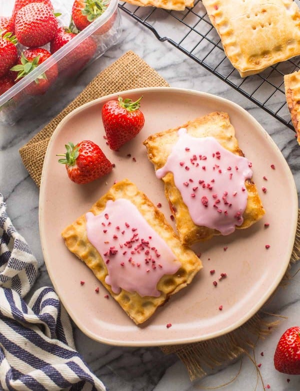 two Strawberry Gluten Free Pop Tarts on pine plate