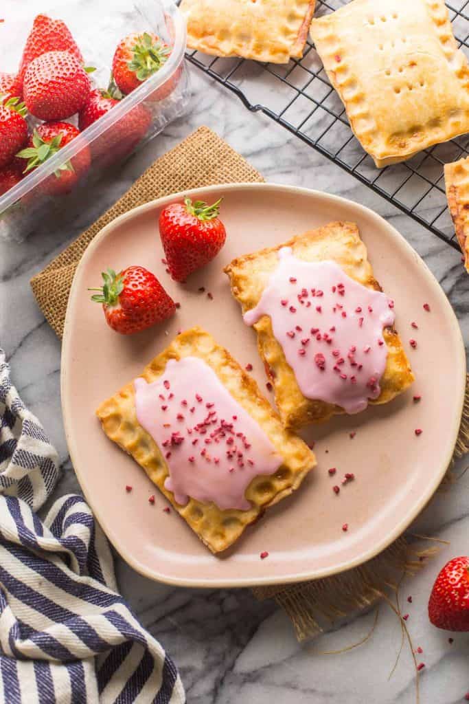  two Strawberry Hand Pies on a pink plate