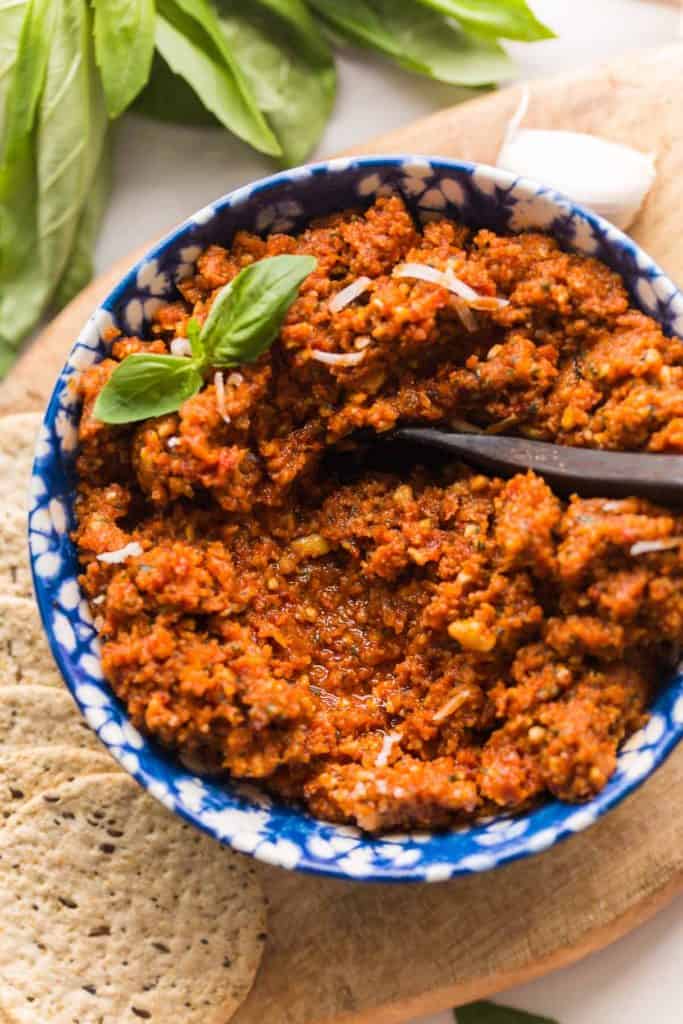 sun dried tomato pesto rosso in a bowl topped with basil