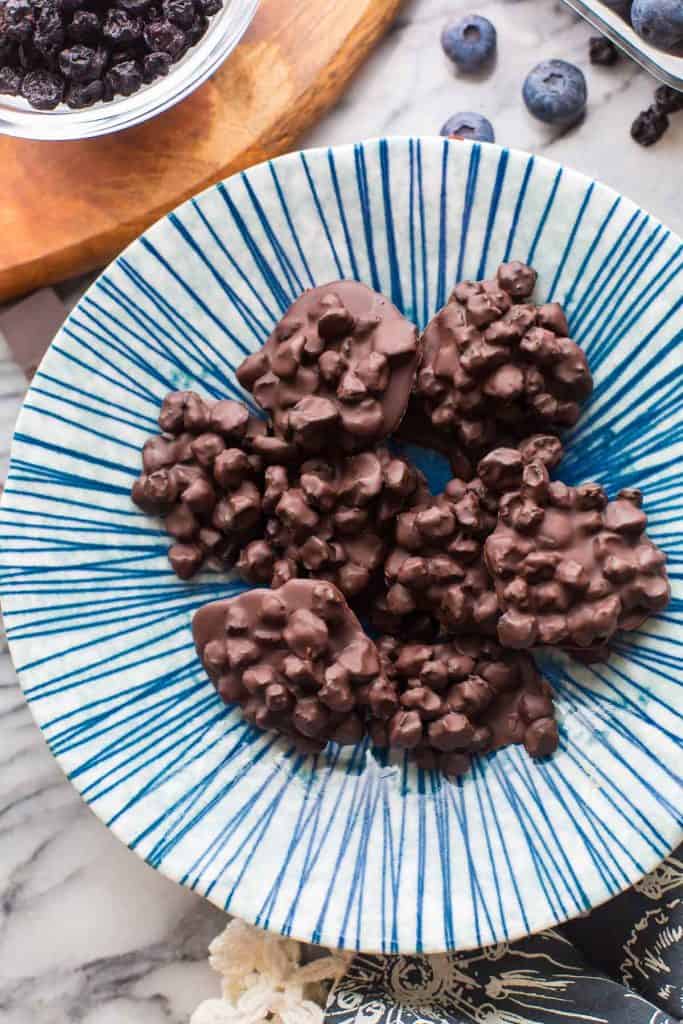 a bunch of Chocolate Covered Blueberries in a striped bowl