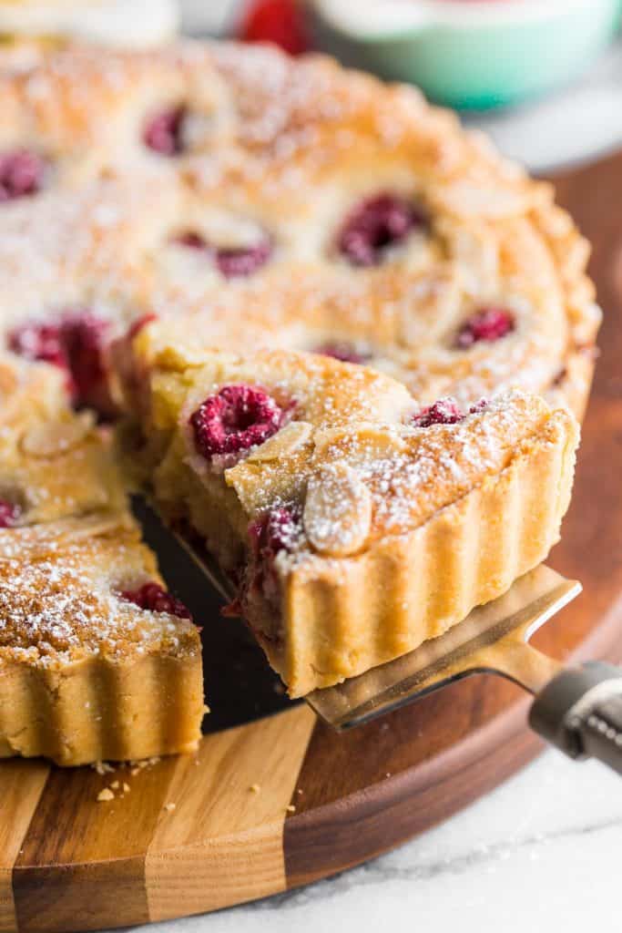 spatula picking up a slice of vegan bakewell tart