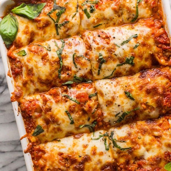 eggplant lasagna in a casserole dish topped with fresh basil