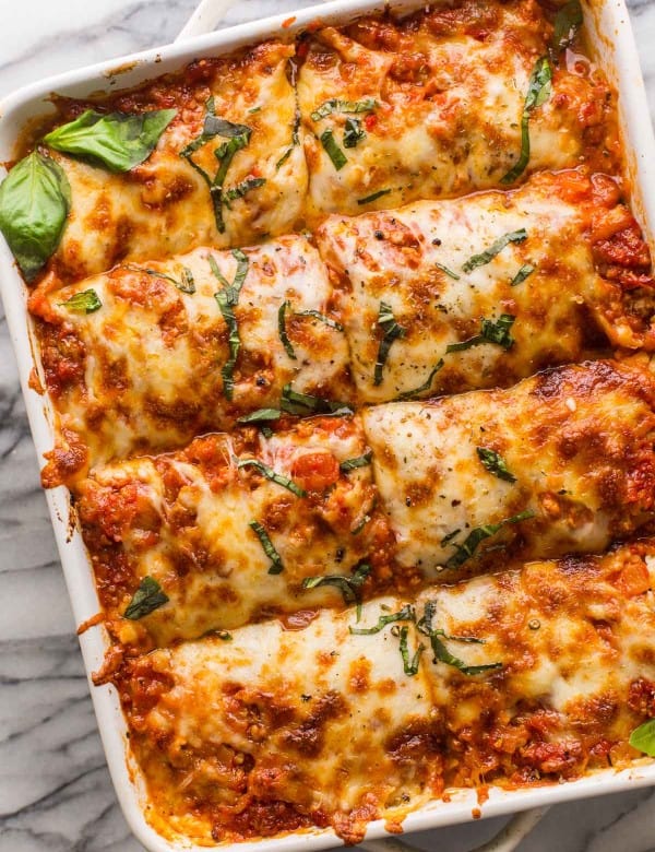 eggplant lasagna in a casserole dish topped with fresh basil