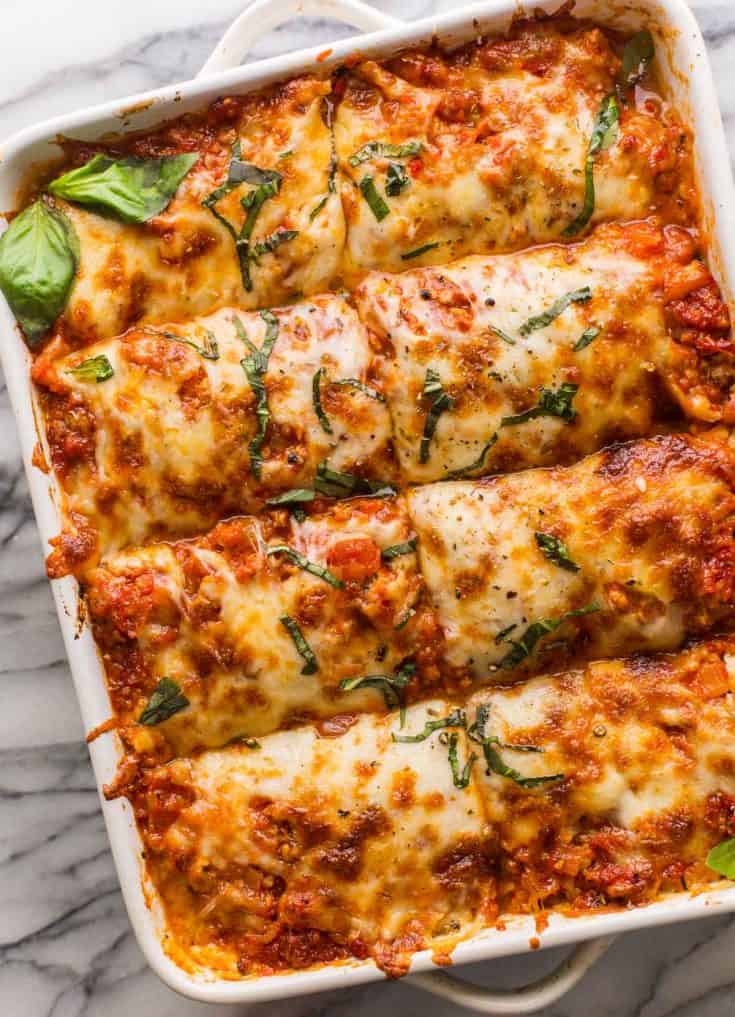 eggplant lasagna in a casserole dish topped with fresh basil