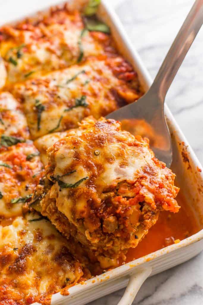 a portion of Roasted Eggplant Lasagna with Turkey held up o na spatula