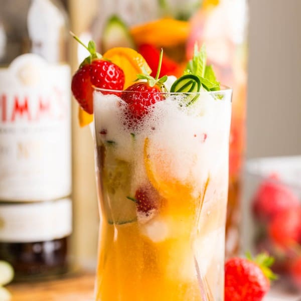 pimm's cup float in a tall glass topped with fruit