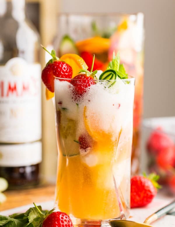 pimm's cup float in a tall glass topped with fruit