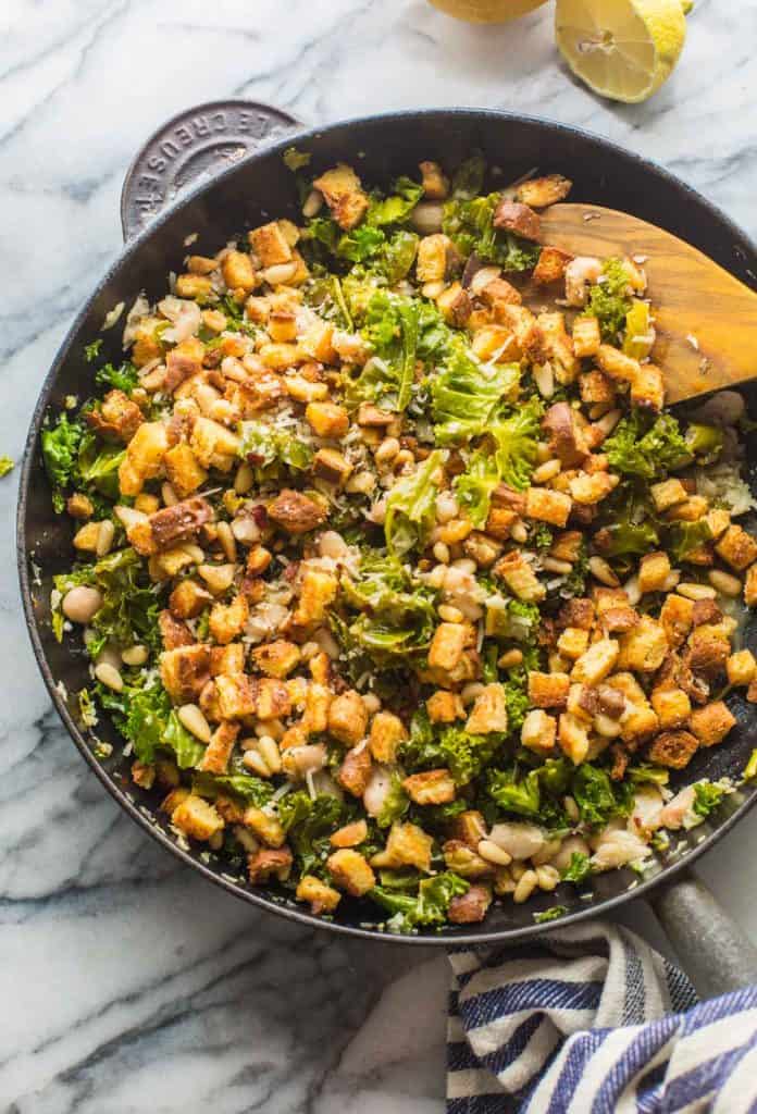 cannellini and kale stir fry in a cast iron skillet 