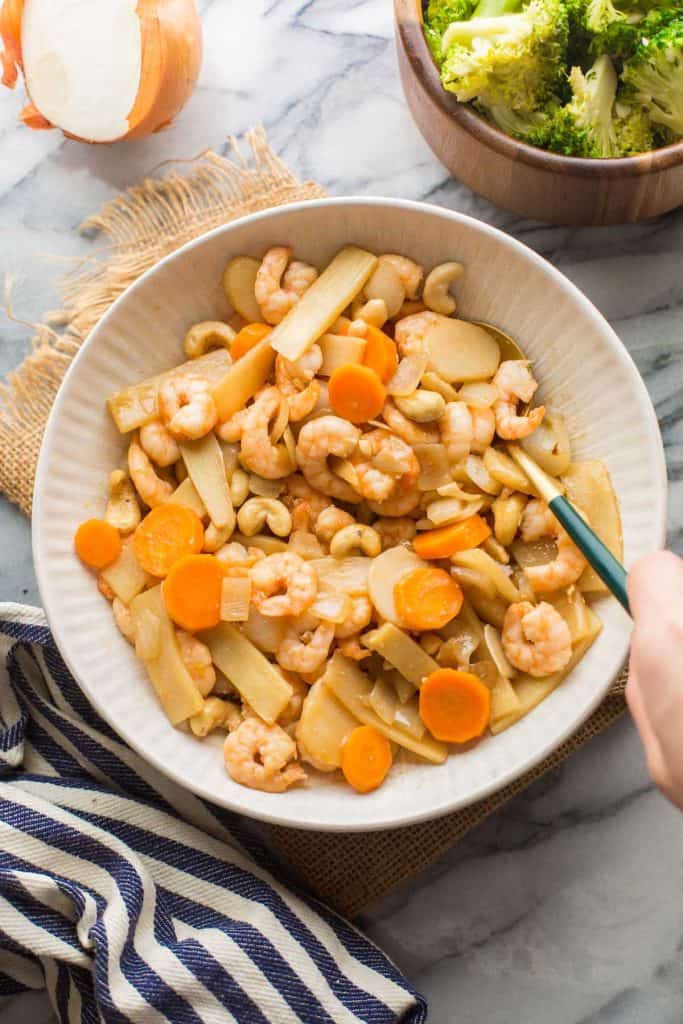 Cashew & King Prawn Stir Fry in a serving bowl with a spoon