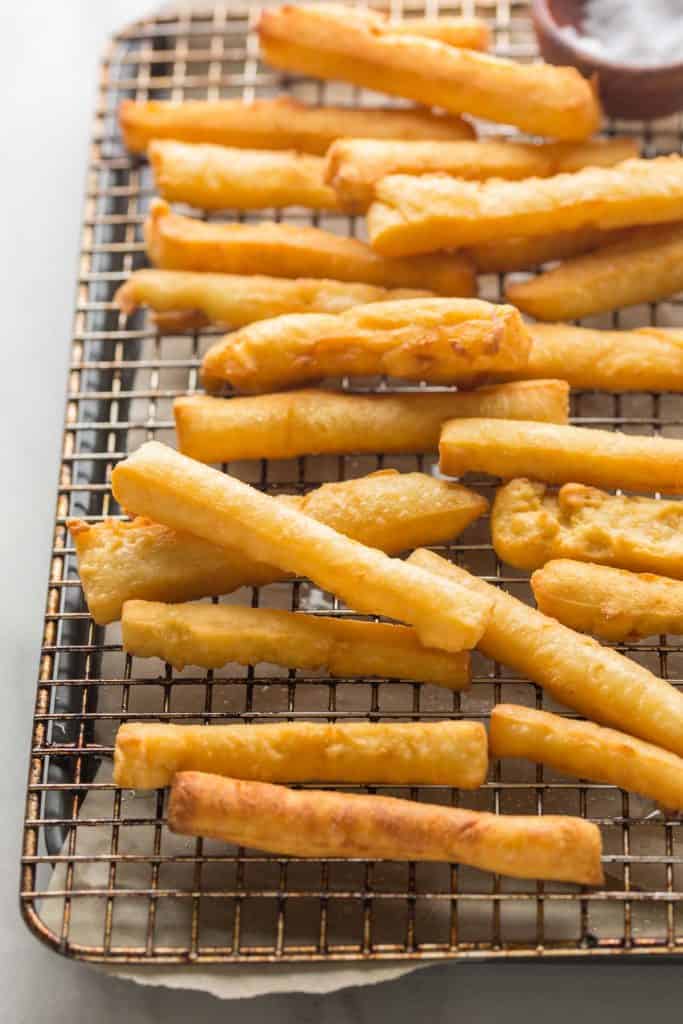 chickpea fries spread out on a wire cooling rack