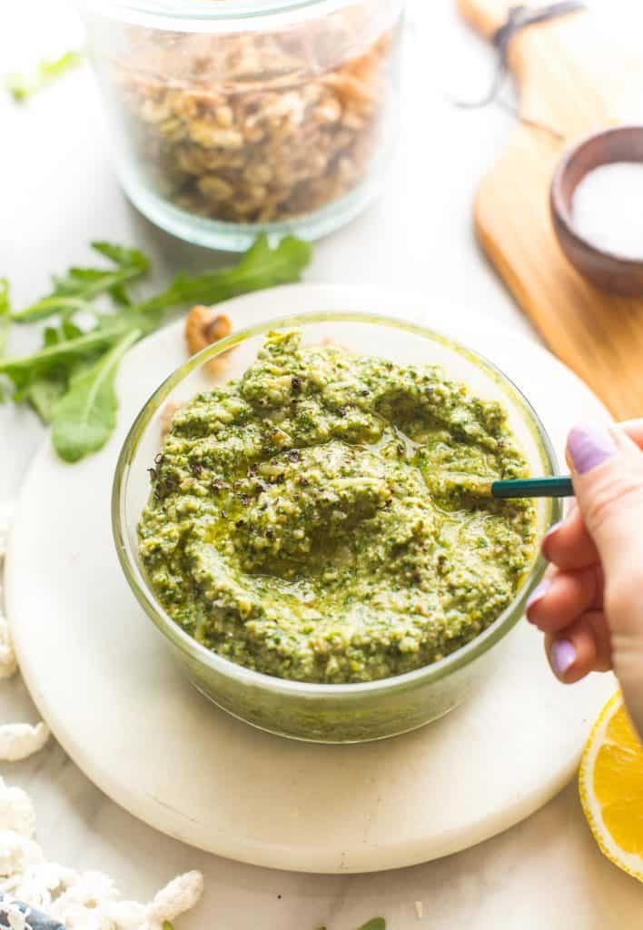 spoon mixing up rocket pesto